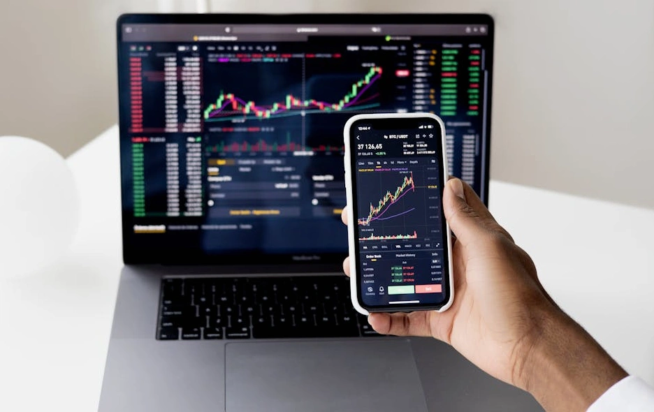 A person analyzing complex financial charts and data visualizations on a modern laptop screen.
